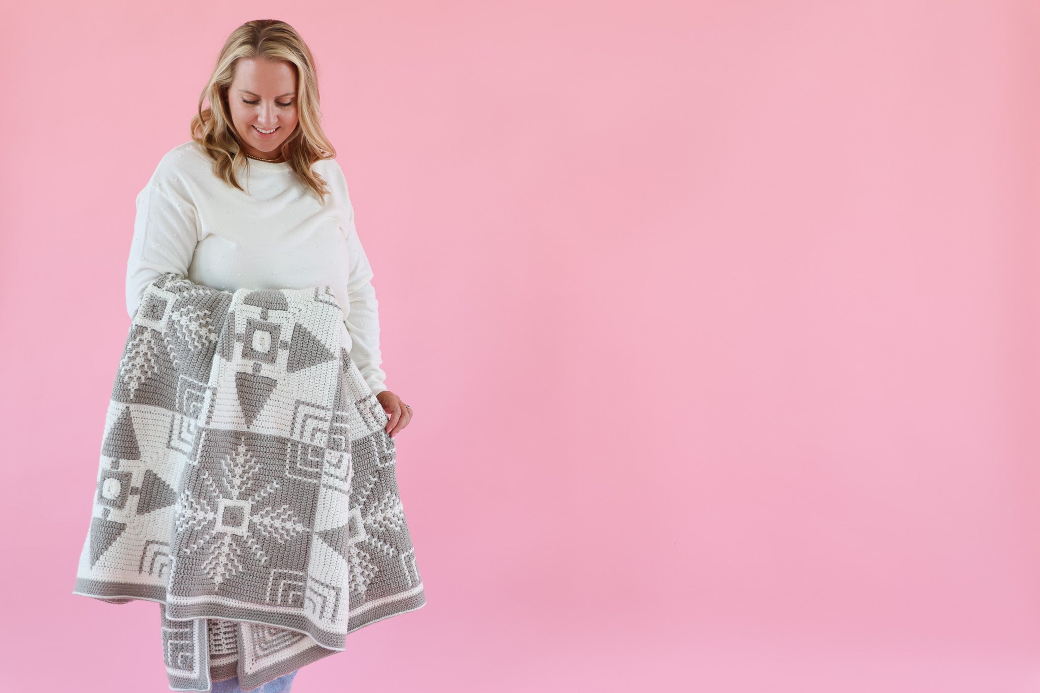 Woman holding crochet blanket